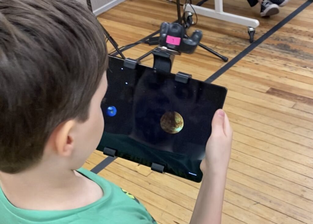 2023 Summer Camp students exploring the virtual solar system experience created by ARIES at the Science Museum of Western Virginia.